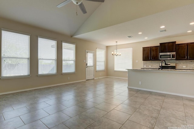 913 Pipe Gate, Cibolo, TX 78108 - kitchen with appliances with stainless steel finishes, a ceiling fan, tasteful backsplash, a chandelier, and dark brown cabinetry