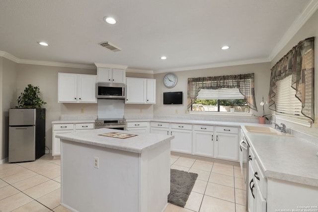 14211 Edge Pt, San Antonio, TX 78230 - kitchen featuring stainless steel appliances, light tile patterned flooring, crown molding, light countertops, and a center island
