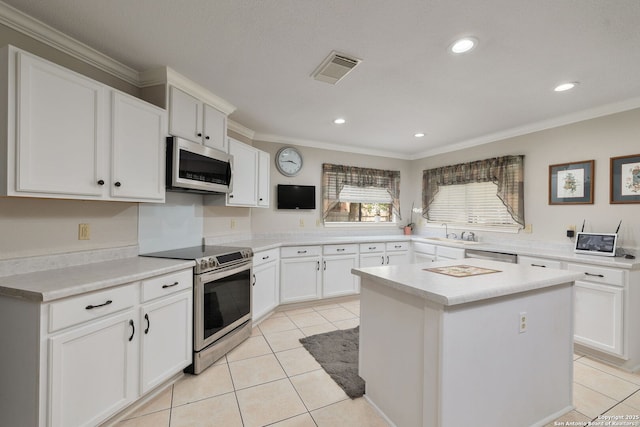 14211 Edge Pt, San Antonio, TX 78230 - kitchen featuring appliances with stainless steel finishes, light tile patterned flooring, a sink, light countertops, and ornamental molding