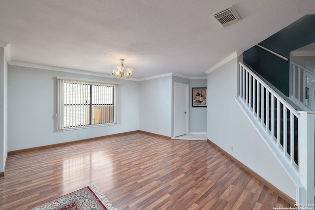 14211 Edge Pt, San Antonio, TX 78230 - unfurnished living room with wood finished floors, a chandelier, baseboards, a textured ceiling, and ornamental molding