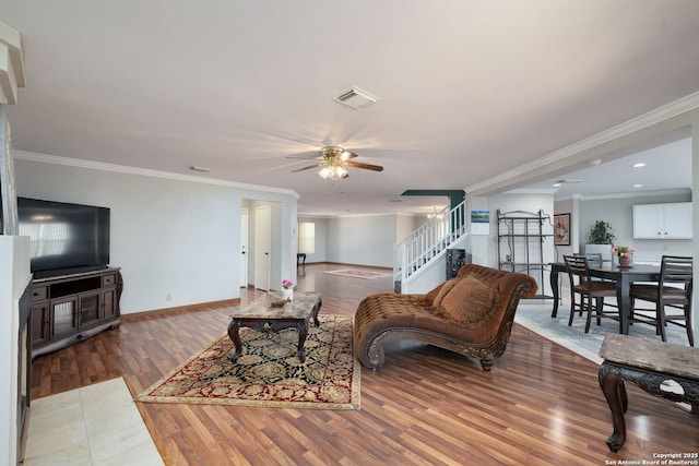 14211 Edge Pt, San Antonio, TX 78230 - living area with ceiling fan, stairs, wood finished floors, ornamental molding, and baseboards