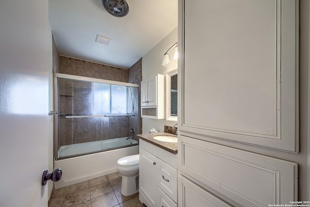 3206 Bluefield, San Antonio, TX 78230 - bathroom featuring toilet, vanity, shower / bath combination with glass door, and tile patterned floors