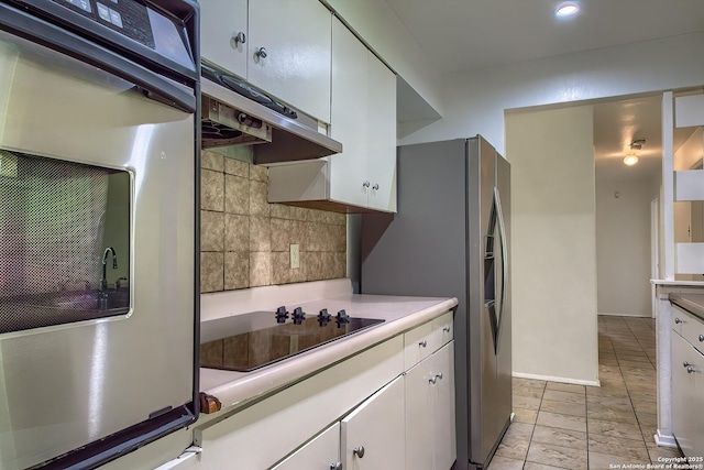3206 Bluefield, San Antonio, TX 78230 - kitchen featuring appliances with stainless steel finishes, decorative backsplash, light countertops, under cabinet range hood, and white cabinetry