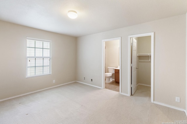 4519 Jeffs Farm, San Antonio, TX 78244 - unfurnished bedroom featuring light colored carpet, a spacious closet, ensuite bathroom, and a closet