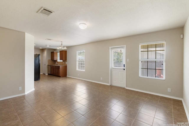 4519 Jeffs Farm, San Antonio, TX 78244 - unfurnished living room featuring a chandelier and tile patterned floors