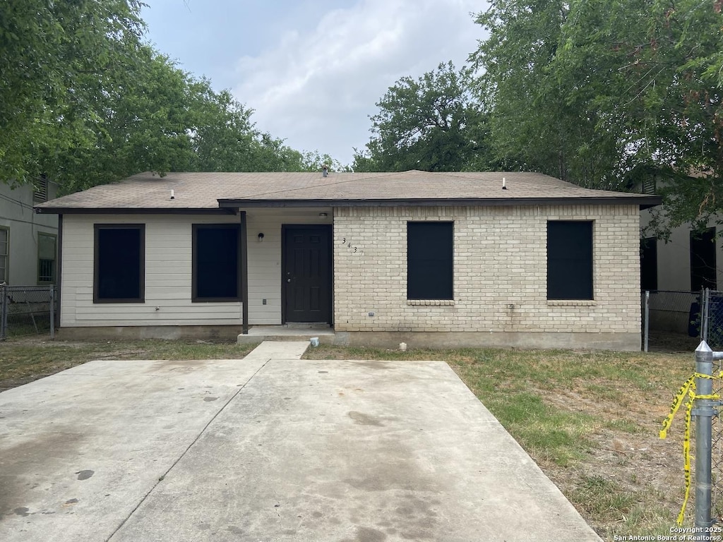 3435 Gateway Dr, San Antonio, TX 78210 - view of front of house featuring a shingled roof and a patio area