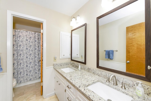 1415 Synandra, San Antonio, TX 78232 - bathroom with double vanity, toilet, curtained shower, and tile patterned flooring