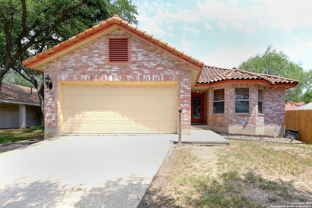 7410 Tom Watson, San Antonio, TX 78244 - view of front of home featuring a tile roof, an attached garage, brick siding, and concrete driveway