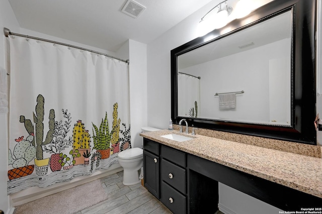 7410 Tom Watson, San Antonio, TX 78244 - full bath featuring toilet, vanity, a shower with curtain, and wood finished floors