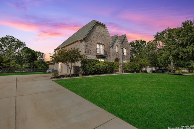 11227 Raw Sienna, Helotes, TX 78023 - view of front of home with brick siding, concrete driveway, and a balcony