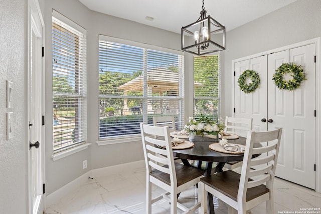 11227 Raw Sienna, Helotes, TX 78023 - dining area with light marble finish floors, baseboards, and a chandelier