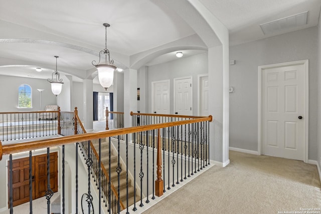 11227 Raw Sienna, Helotes, TX 78023 - corridor with an upstairs landing, carpet, arched walkways, and baseboards