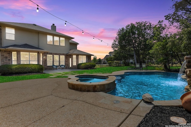 11227 Raw Sienna, Helotes, TX 78023 - pool at dusk featuring a patio area and a pool with connected hot tub