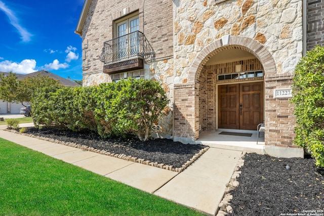 11227 Raw Sienna, Helotes, TX 78023 - view of exterior entry with stone siding, brick siding, and a balcony