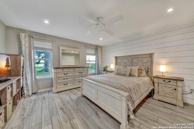 15592 Miller, Saint Hedwig, TX 78152 - bedroom with recessed lighting, light wood-style flooring, baseboards, ceiling fan, and wood walls