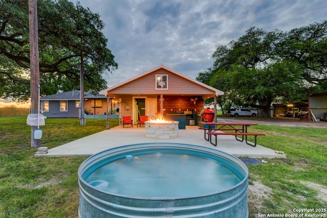 15592 Miller, Saint Hedwig, TX 78152 - rear view of house featuring a lawn, a patio, and an outdoor fire pit