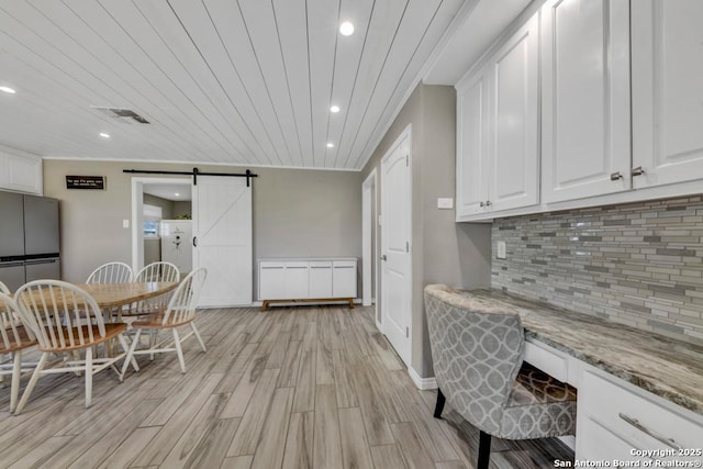 15592 Miller, Saint Hedwig, TX 78152 - dining area with a barn door, recessed lighting, light wood-style floors, baseboards, and crown molding