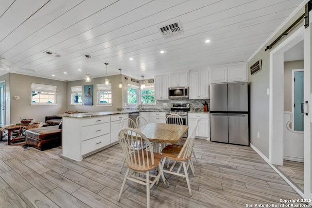 15592 Miller, Saint Hedwig, TX 78152 - dining space featuring healthy amount of natural light, light wood-type flooring, recessed lighting, wooden ceiling, and a barn door