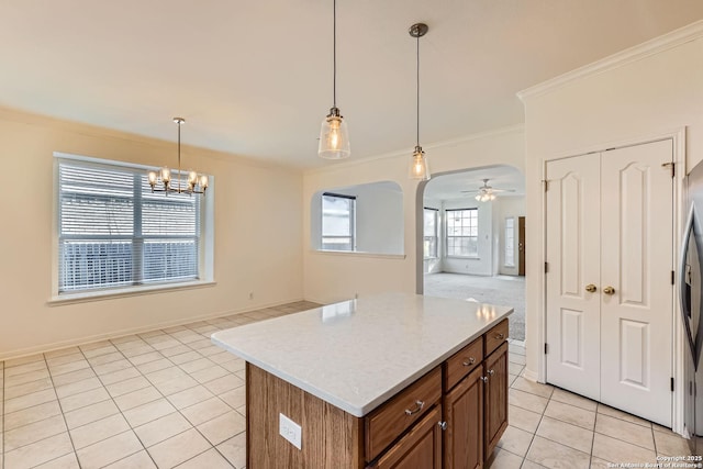 2510 Sage Holw, San Antonio, TX 78251 - kitchen with light tile patterned floors, ornamental molding, open floor plan, brown cabinetry, and a ceiling fan