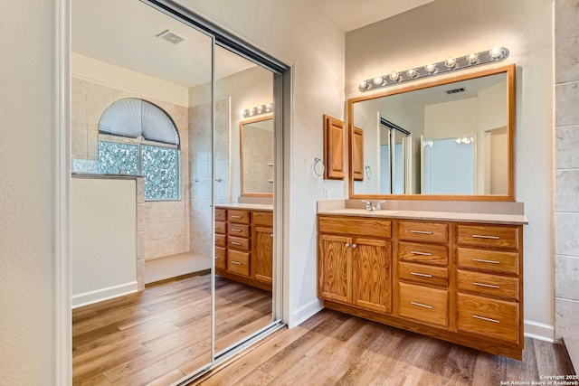 2510 Sage Holw, San Antonio, TX 78251 - full bath with vanity, wood finished floors, and walk in shower