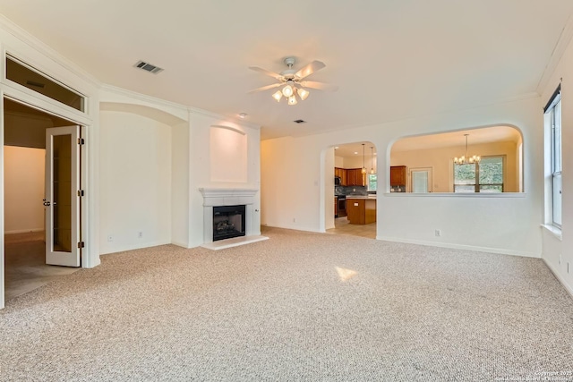 2510 Sage Holw, San Antonio, TX 78251 - unfurnished living room featuring a ceiling fan, a chandelier, a fireplace, light carpet, and baseboards