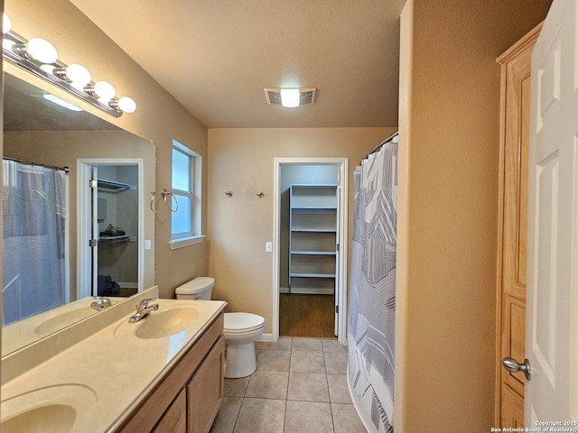 2115 Bentwood, New Braunfels, TX 78130 - bathroom with toilet, a closet, double vanity, tile patterned flooring, and a shower with shower curtain