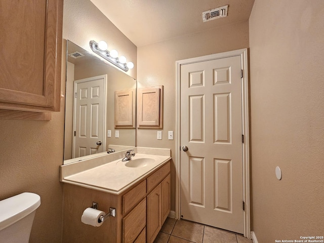 2115 Bentwood, New Braunfels, TX 78130 - half bath with tile patterned floors, vanity, toilet, and baseboards