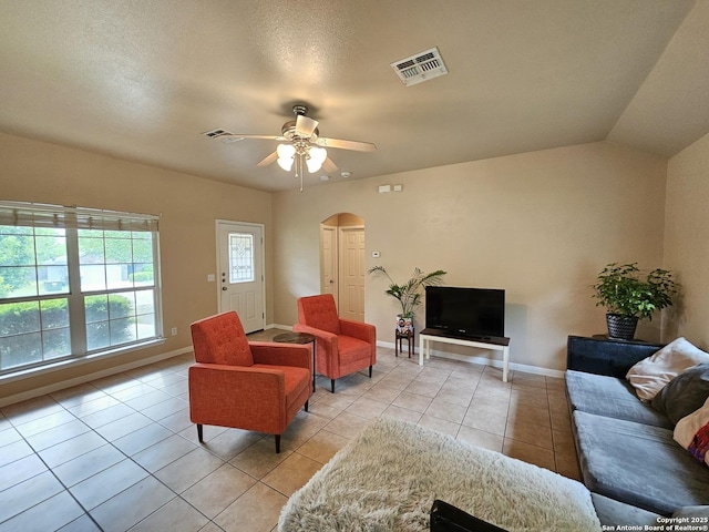 2115 Bentwood, New Braunfels, TX 78130 - living area with light tile patterned floors, arched walkways, a ceiling fan, and baseboards
