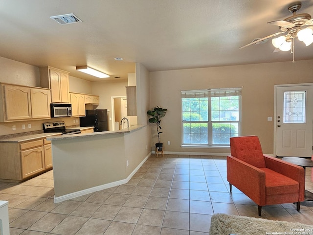 2115 Bentwood, New Braunfels, TX 78130 - kitchen featuring appliances with stainless steel finishes, a ceiling fan, light tile patterned floors, and light countertops