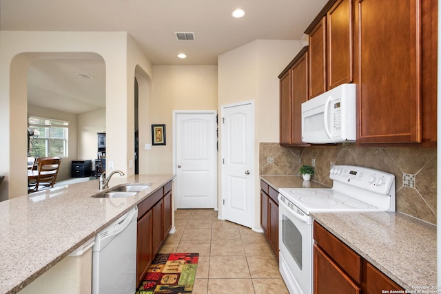7411 Virtuoso, San Antonio, TX 78266 - kitchen with white appliances, a sink, light stone countertops, light tile patterned flooring, and tasteful backsplash