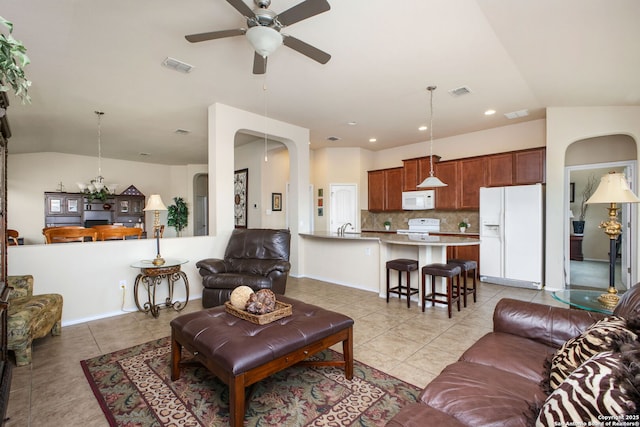 7411 Virtuoso, San Antonio, TX 78266 - living room featuring light tile patterned flooring, a ceiling fan, lofted ceiling, arched walkways, and recessed lighting