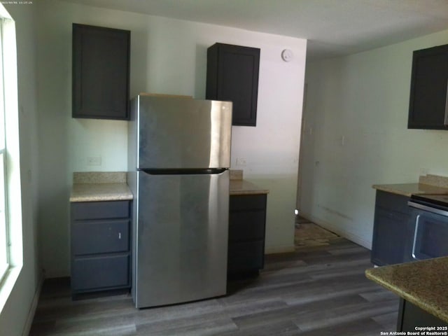2619 E Houston St, San Antonio, TX 78202 - kitchen with stainless steel appliances, wood finished floors, and light countertops