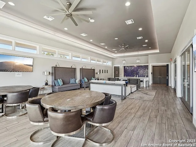 23402 Grande Vis, San Antonio, TX 78261 - dining room with ceiling fan, a tray ceiling, light wood-type flooring, and recessed lighting