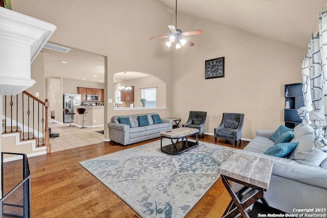 1427 Sparrow Song, San Antonio, TX 78260 - living area featuring ceiling fan, light wood finished floors, stairs, arched walkways, and high vaulted ceiling