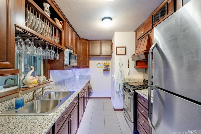 243 Future Dr, San Antonio, TX 78213 - kitchen featuring appliances with stainless steel finishes, a sink, custom exhaust hood, light tile patterned floors, and baseboards