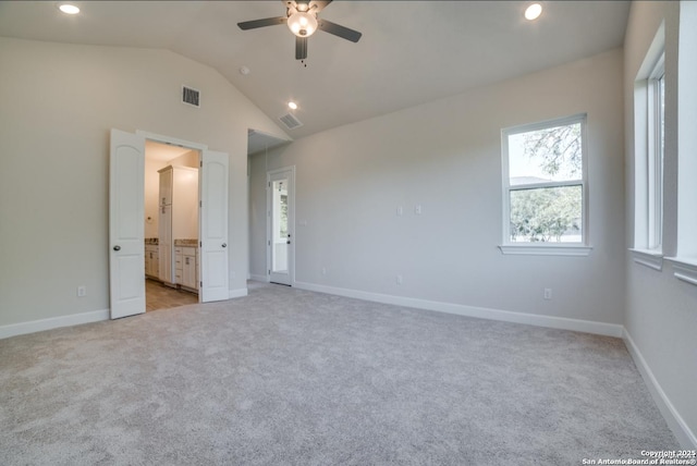 8119 Ventura Blvd, Selma, TX 78154 - unfurnished bedroom with light colored carpet, recessed lighting, vaulted ceiling, baseboards, and connected bathroom