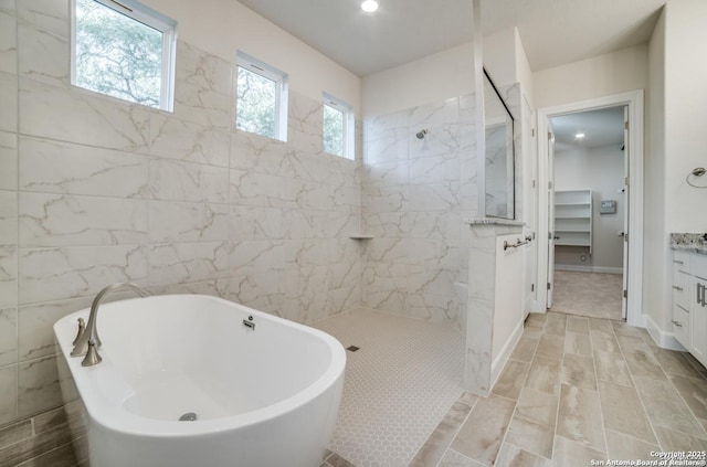 8119 Ventura Blvd, Selma, TX 78154 - bathroom with a marble finish shower, a freestanding tub, vanity, and recessed lighting
