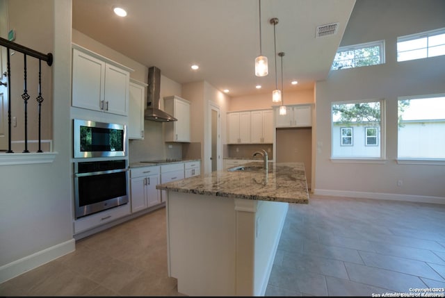 8119 Ventura Blvd, Selma, TX 78154 - kitchen featuring appliances with stainless steel finishes, a sink, wall chimney range hood, baseboards, and white cabinets