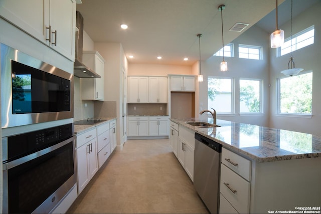 8119 Ventura Blvd, Selma, TX 78154 - kitchen featuring appliances with stainless steel finishes, a sink, wall chimney exhaust hood, decorative light fixtures, and white cabinets