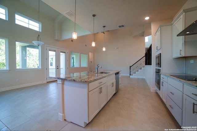 8119 Ventura Blvd, Selma, TX 78154 - kitchen with appliances with stainless steel finishes, a high ceiling, baseboards, pendant lighting, and light stone countertops