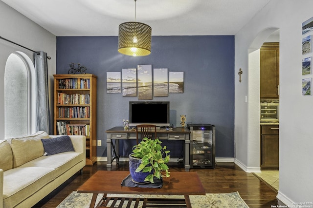 18131 Muir Glen Dr, San Antonio, TX 78257 - living area featuring arched walkways, wine cooler, wood finished floors, and baseboards