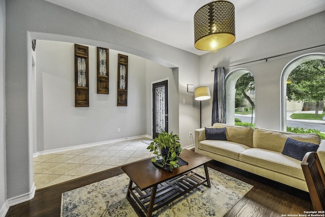 18131 Muir Glen Dr, San Antonio, TX 78257 - living room with arched walkways, wood finished floors, and baseboards