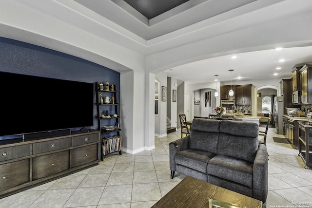 18131 Muir Glen Dr, San Antonio, TX 78257 - living room featuring arched walkways, light tile patterned floors, recessed lighting, and baseboards