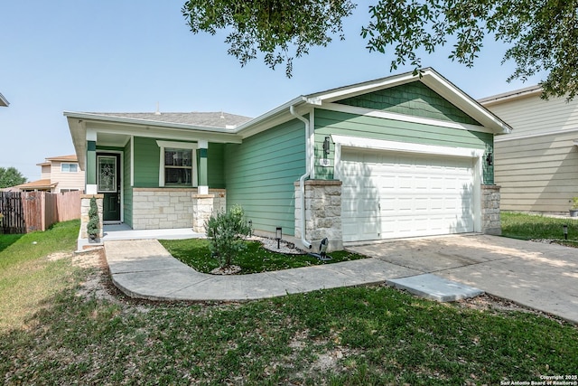 1023 Sundance Fall, San Antonio, TX 78245 - view of front of home featuring stone siding, an attached garage, and driveway
