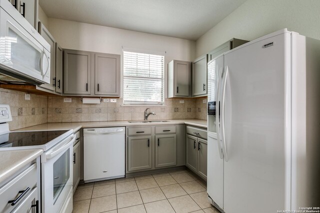 1023 Sundance Fall, San Antonio, TX 78245 - kitchen featuring white appliances, a sink, gray cabinetry, backsplash, and light tile patterned floors