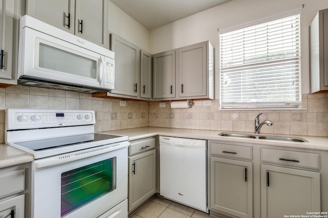 1023 Sundance Fall, San Antonio, TX 78245 - kitchen with white appliances, a sink, light countertops, and tasteful backsplash