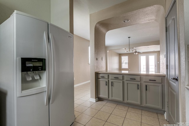 1023 Sundance Fall, San Antonio, TX 78245 - kitchen featuring refrigerator with ice dispenser, light tile patterned floors, a chandelier, light countertops, and gray cabinets