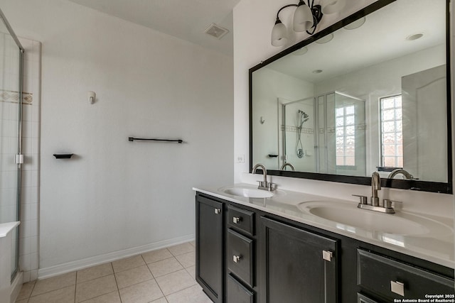 1023 Sundance Fall, San Antonio, TX 78245 - bathroom featuring double vanity, tile patterned flooring, a stall shower, and baseboards