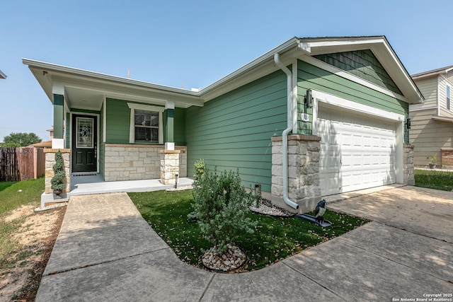 1023 Sundance Fall, San Antonio, TX 78245 - view of front of house featuring stone siding, driveway, and an attached garage