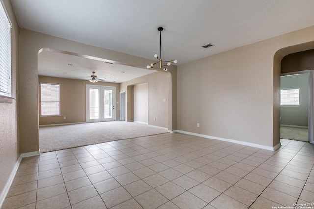 1023 Sundance Fall, San Antonio, TX 78245 - spare room with arched walkways, light colored carpet, baseboards, and a ceiling fan
